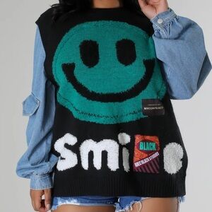 Black and Green Smiley Face Sweater with denim sleeves. Small/medium